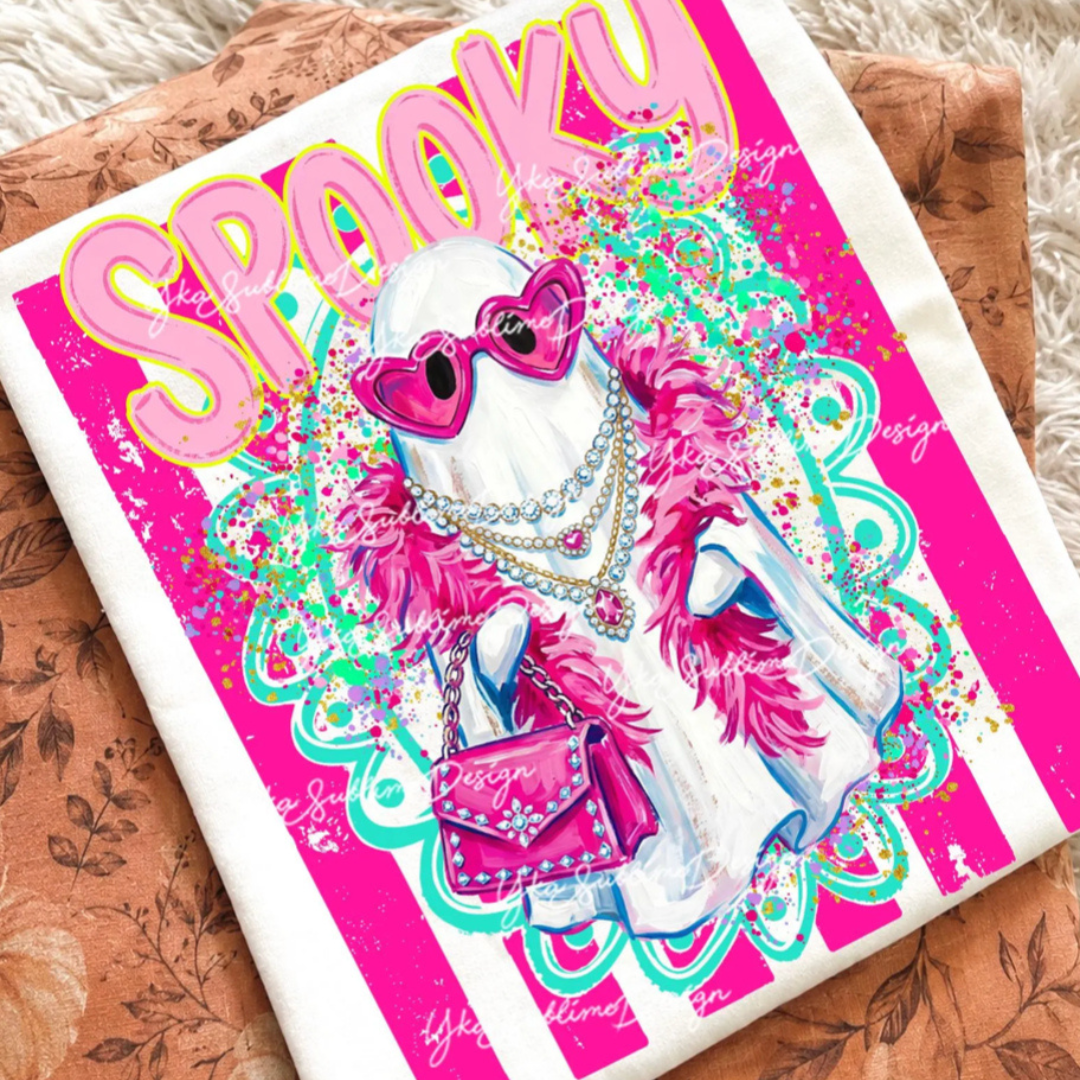 Cream graphic tee featuring a fashionable ghost wearing heart-shaped sunglasses, layered faux jeweled necklaces, a pink feather boa, and a pink handbag with bold hot pink striped background and faux bling details.