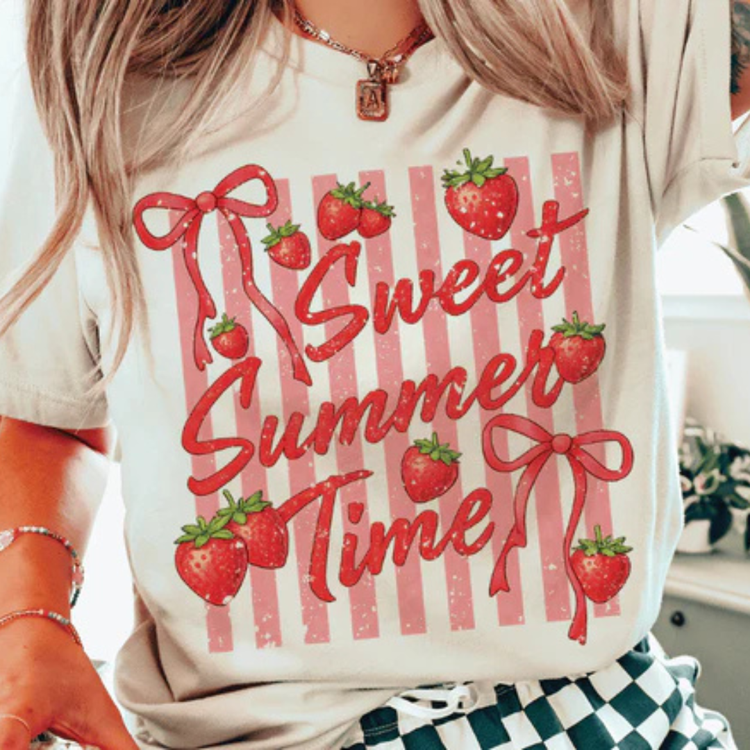 Cream graphic tee featuring a Sweet Summer Time design with strawberries, bows, and pink vintage-inspired stripes.