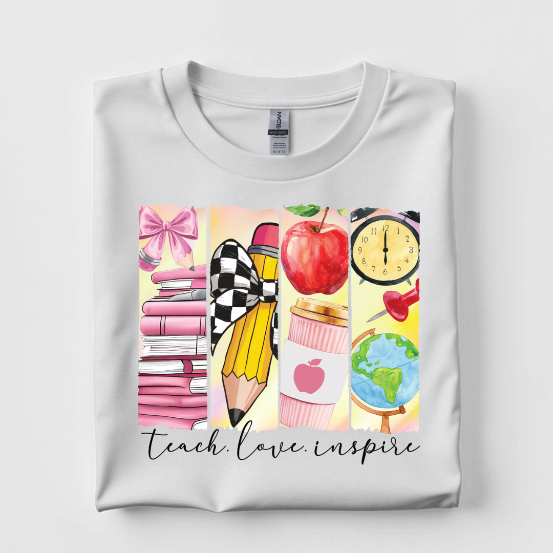 White graphic tee featuring a colorful Teach Love Inspire design with books, pencil, apple, coffee cup, globe, clock, and classroom-themed illustrations.
