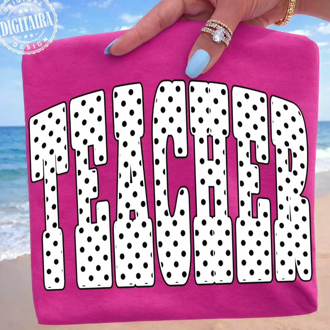 Hot pink graphic teacher tee featuring oversized black and white polka dot "Teacher" lettering.