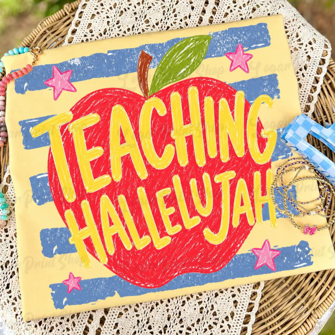 Butter yellow teacher graphic tee featuring a large red apple, blue stripes, and the phrase "Teaching Hallelujah."
