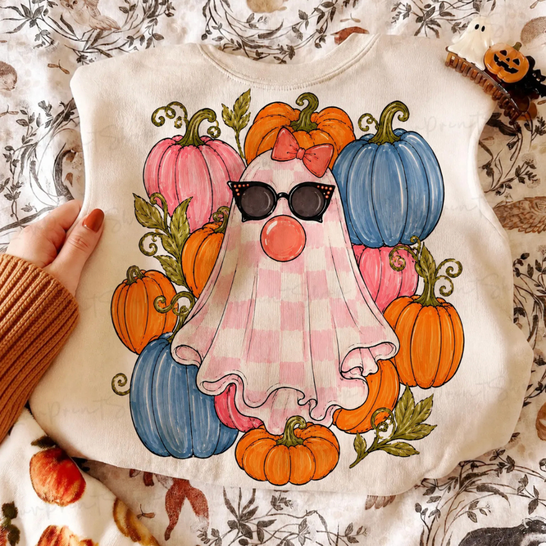 Natural Halloween graphic tee featuring a pink gingham ghost wearing sunglasses and blowing a bubblegum bubble, surrounded by colorful pink, blue, and orange pumpkins.