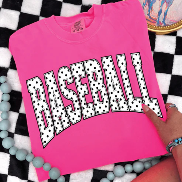 Comfort Colors graphic t-shirt featuring a bold BASEBALL design with classic black and white polka dot lettering.