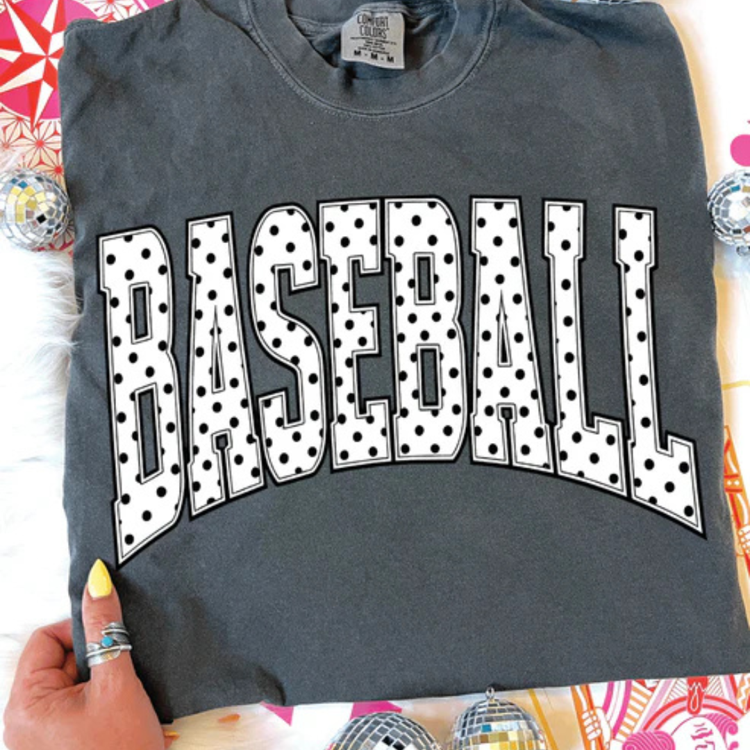 Comfort Colors graphic t-shirt featuring a bold BASEBALL design with classic black and white polka dot lettering.