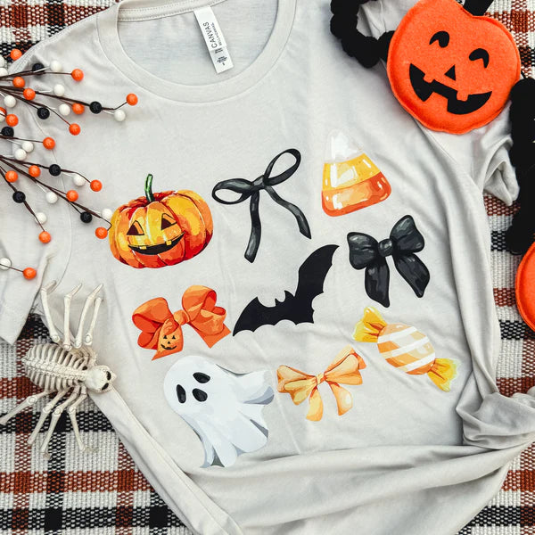 White t-shirt with Halloween-themed graphics on a plaid fabric background