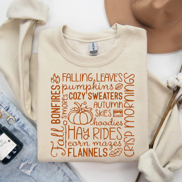 Beige sweatshirt with autumn-themed text on a white background