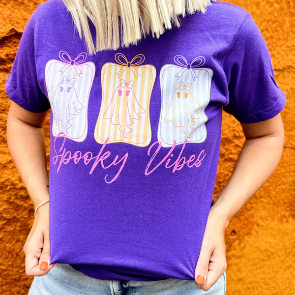 Person wearing a purple t-shirt with &