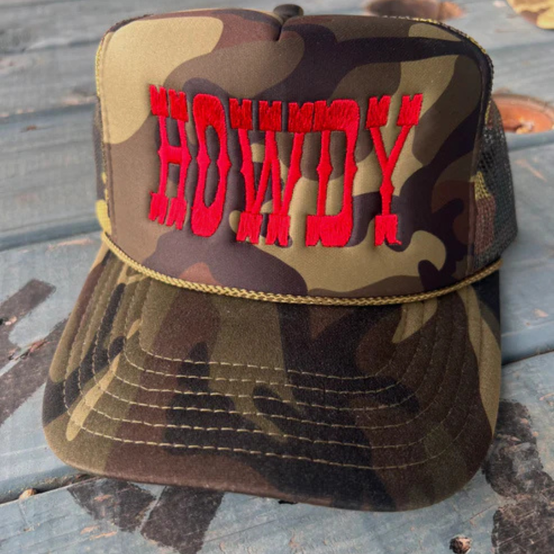 Camouflage trucker hat featuring bold red embroidered Howdy lettering with an adjustable mesh back.