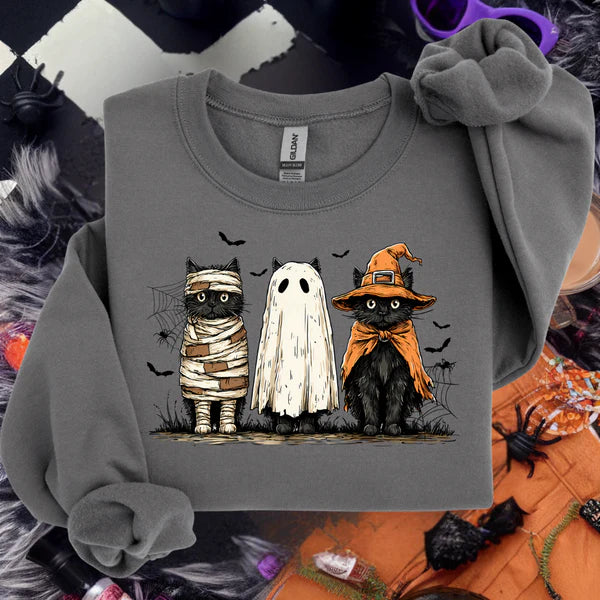 Gray sweatshirt with Halloween-themed cat illustrations on a festive background
