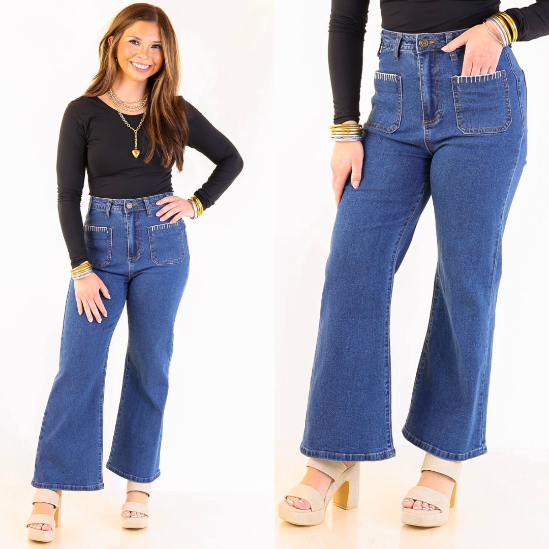 model is wearing blue jeans in dark wash with crochet trim against a plain background