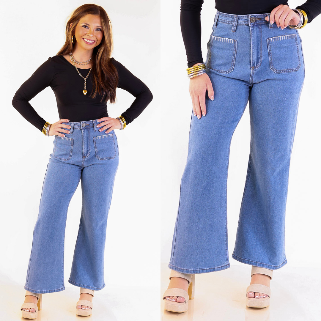 Model is wearing medium wash blue jeans with crochet trim on a white background