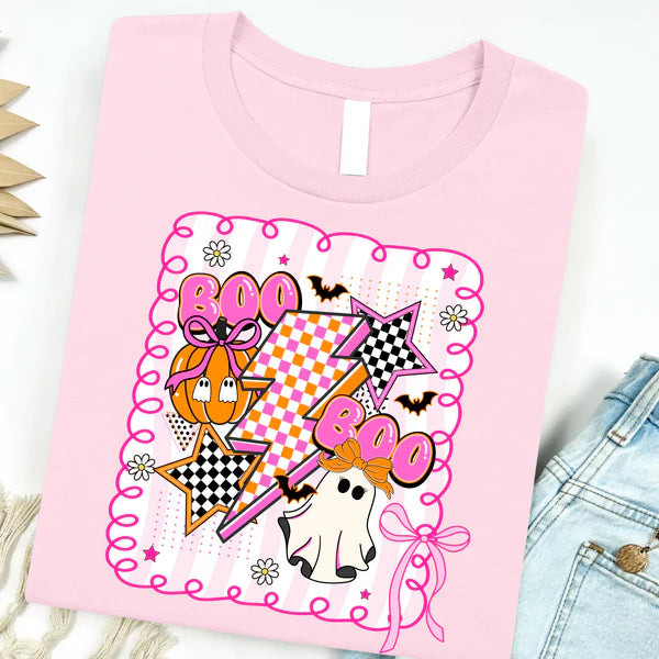 Pink t-shirt with Halloween-themed design featuring ghosts, pumpkins, and stars on a white background.