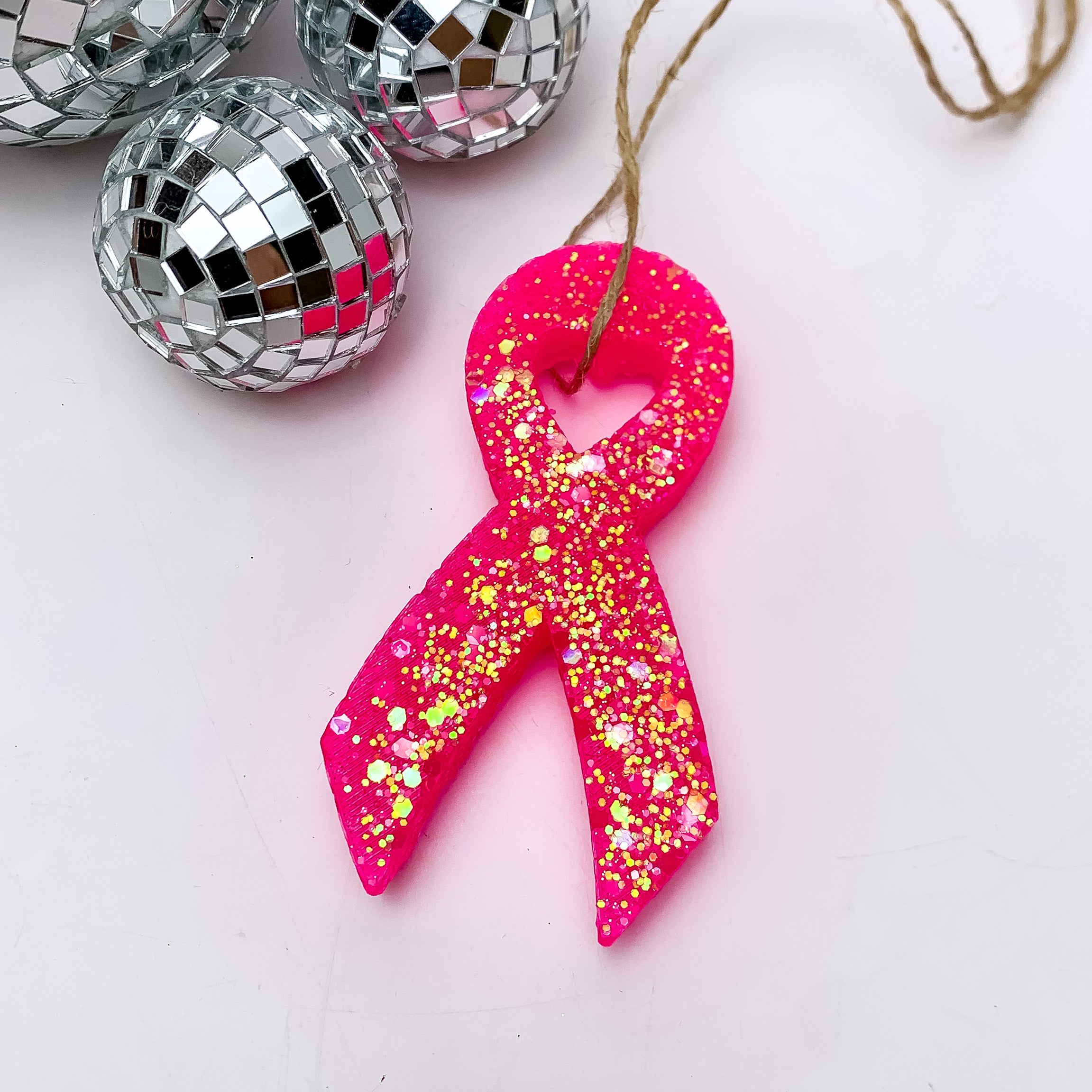 Hot Pink Breast Cancer Ribbon Freshie in Assorted Scents. This freshie is pictured on a white background with disco balls in the corner.