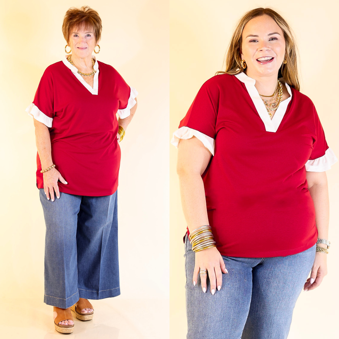 Two women wearing maroon shirts with white trim against a beige background