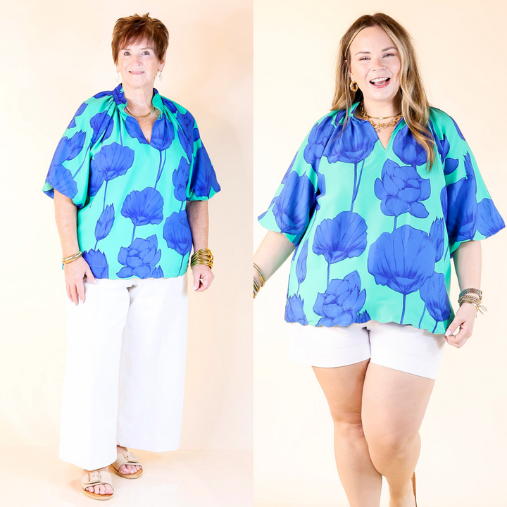 Jade green with bold blue blooms, a flattering V-neck, puff sleeves, and a playful wave hem. Sizes XL through 2X.
