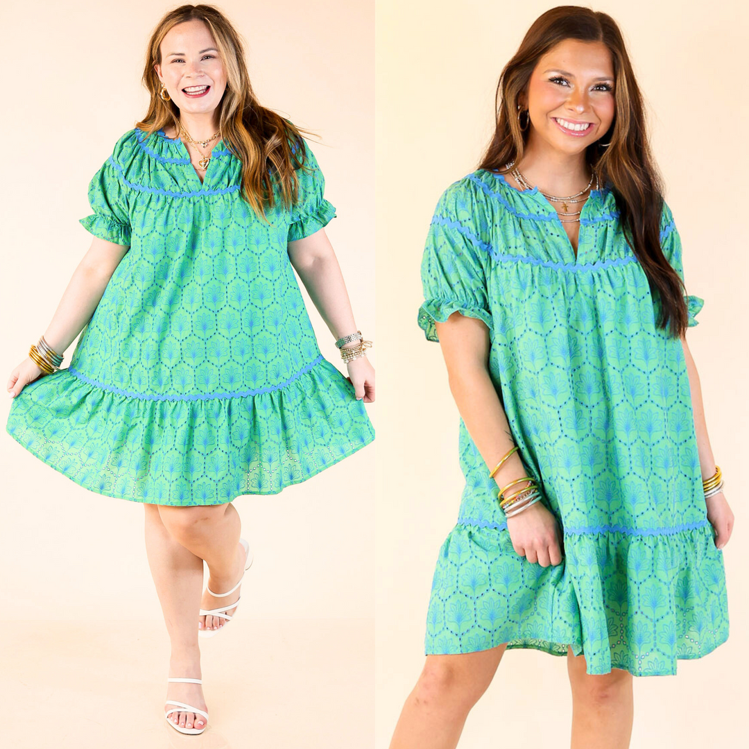 Green short dress with eyelet lace, short puff sleeves, V-neck, blue rickrack detail, available in size small through large.