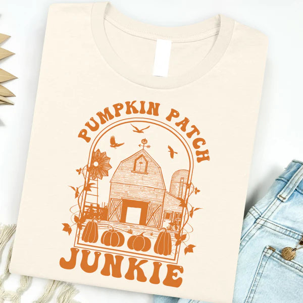 Beige t-shirt with 'Pumpkin Patch Junkie' design featuring a barn and pumpkins on a white background.