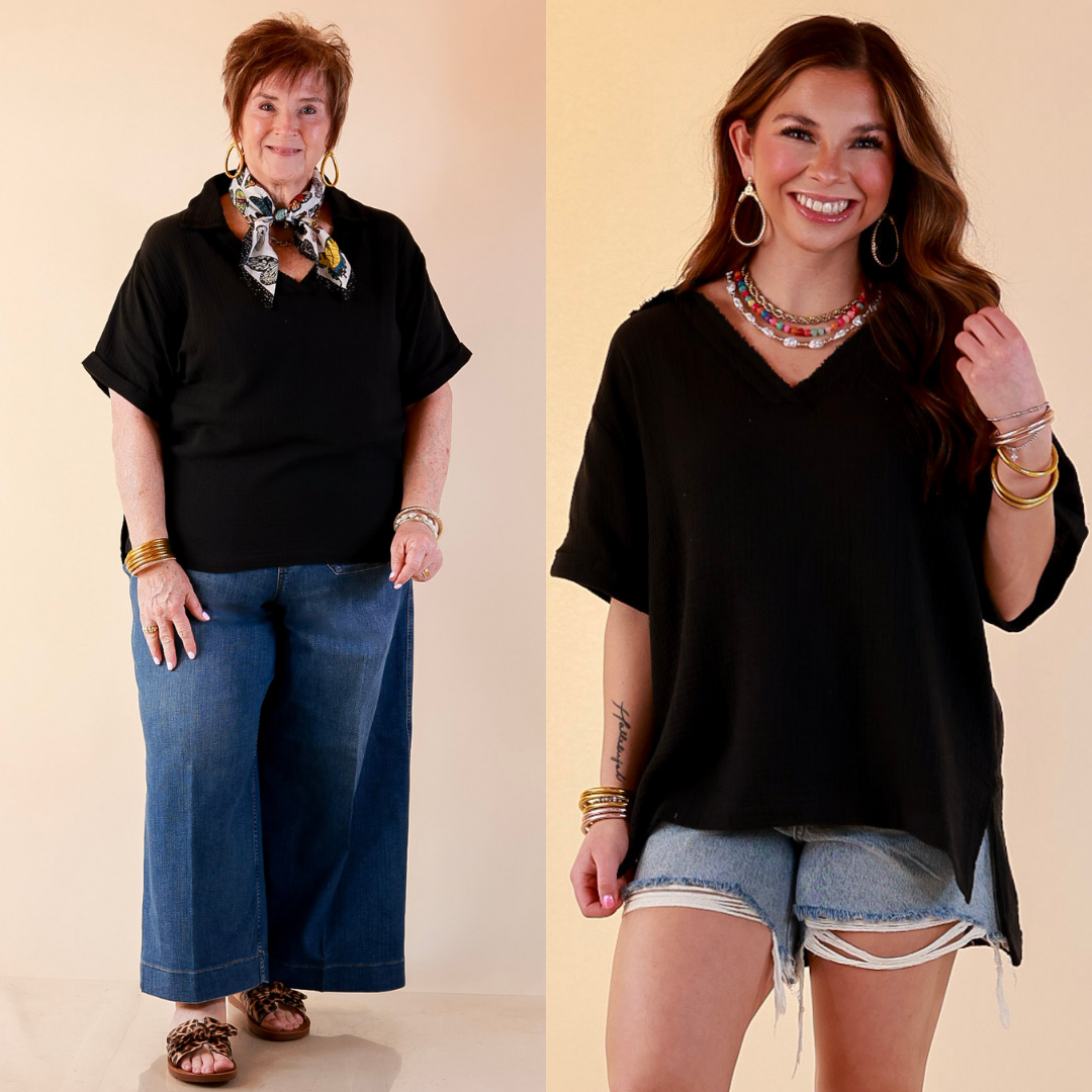 Models are wearing Short Sleeve Collared V-Neck Linen Top with Rolled Sleeve Detail in Black with bottoms against a beige backdrop. 