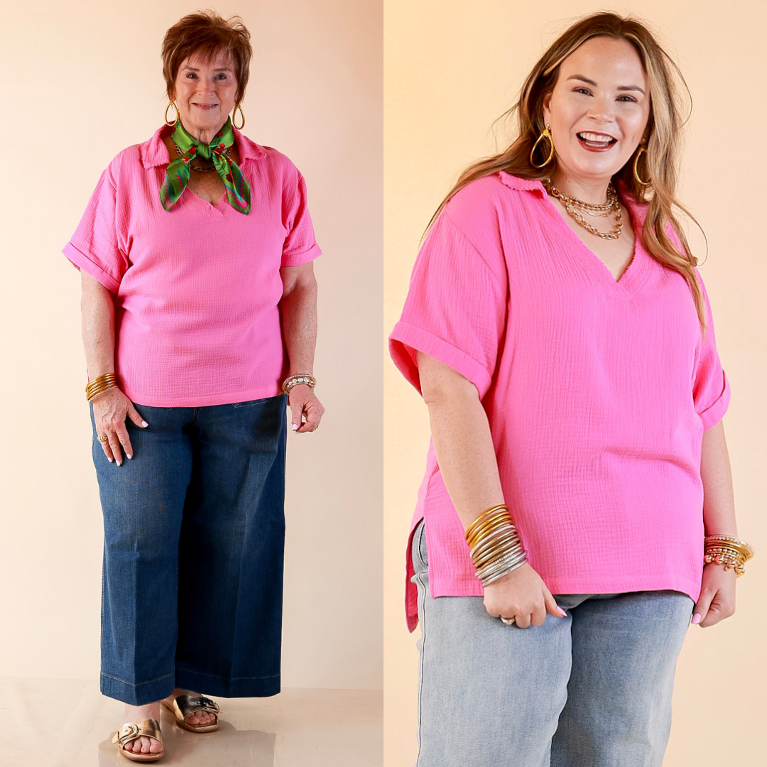 Models are wearing Short Sleeve Collared V-Neck Linen Top with Rolled Sleeve Detail in Pink with bottoms against a beige backdrop. 