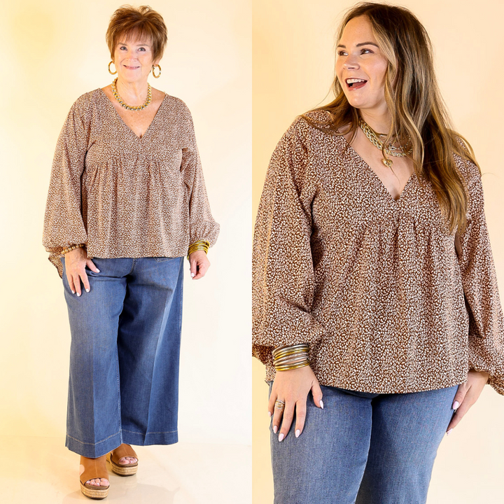 Two women wearing a brown leopard print blouse and blue jeans on a plain background