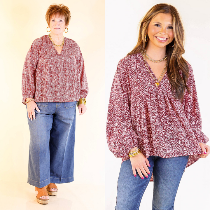 Two women wearing a red leopard print blouse and blue jeans on a beige background