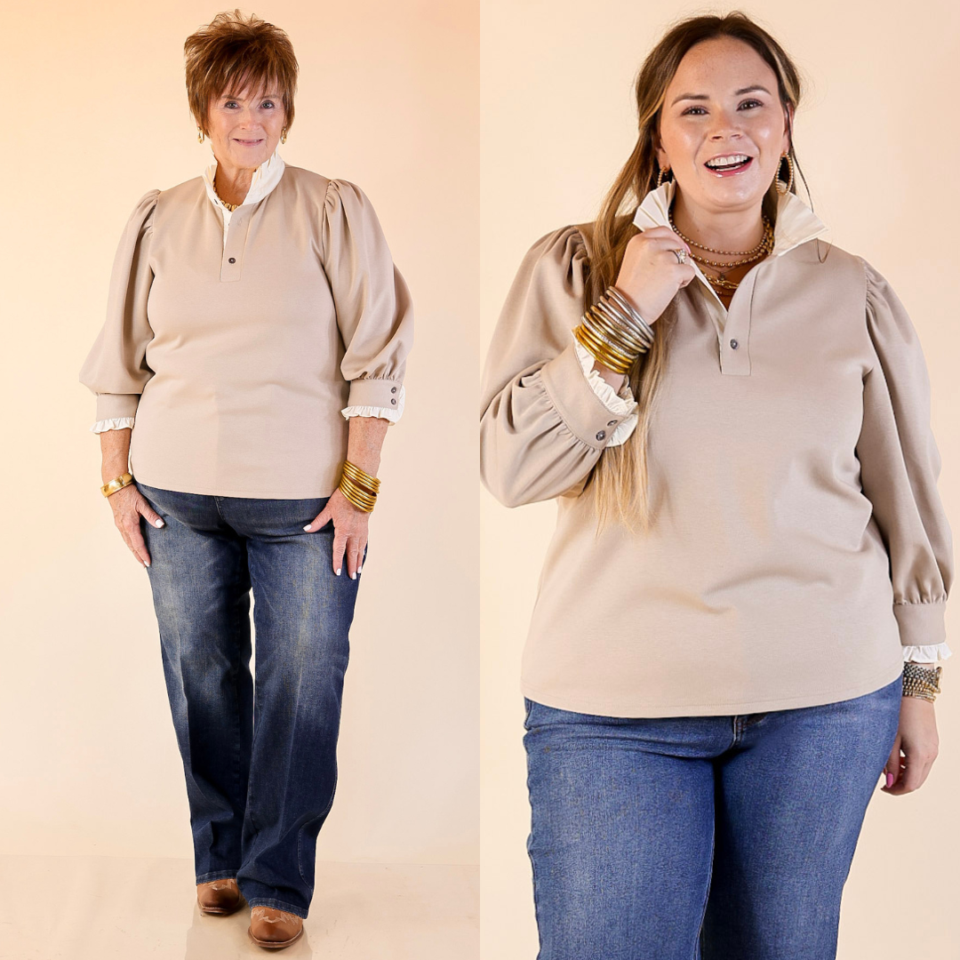 Two women wearing a sand long-sleeve top with collar detailing and blue jeans on a beige background