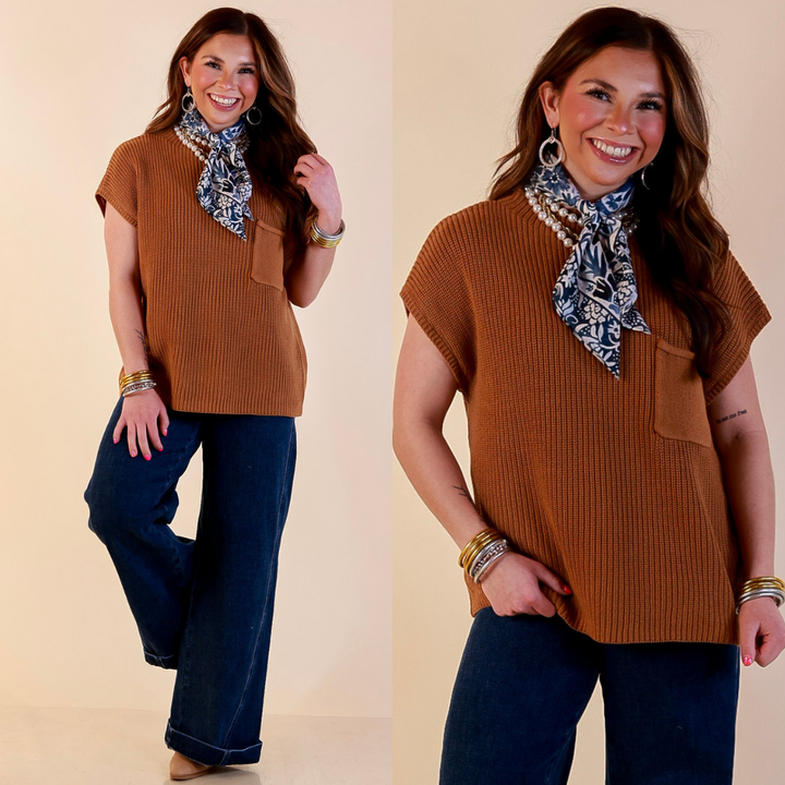 Model is wearing Cap Sleeve Sweater with Front Pocket in Camel Brown with Jeans against a beige backdrop. 