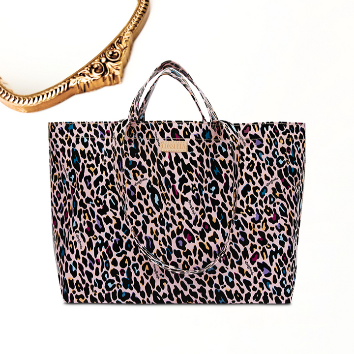 Gold mirror with white background. Ruth bag with a ConsuelaCloth™ exterior and Diego natural leather logo accent. Features an unlined interior, base insert for stability, and both short and long handles with a 4-inch and 14-inch drop.