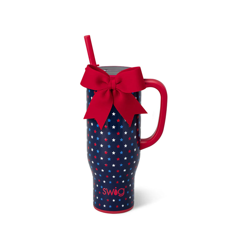 Swig Oh My Stars 30 oz Mega Mug featuring a navy red, white, and blue star print with a handle, reusable straw, and decorative red bow.