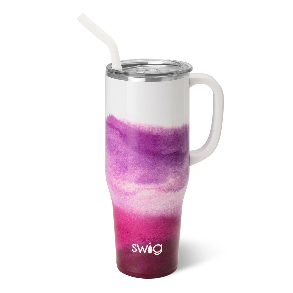 Swig Amethyst 40 oz mega mug. This cup is ombre starting at white going to pink and purple. The cup has a handle and a straw in white. The background of the picture is white.