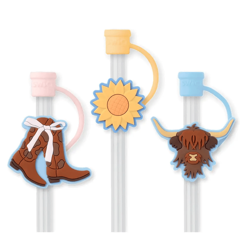 3 reusable straws with 3 silicone toppers. A colored cap that covers the straw opening. Each topper has a icon on it (left to right) Cowgirl boots with white bow, sunflower, long-haired cow head.