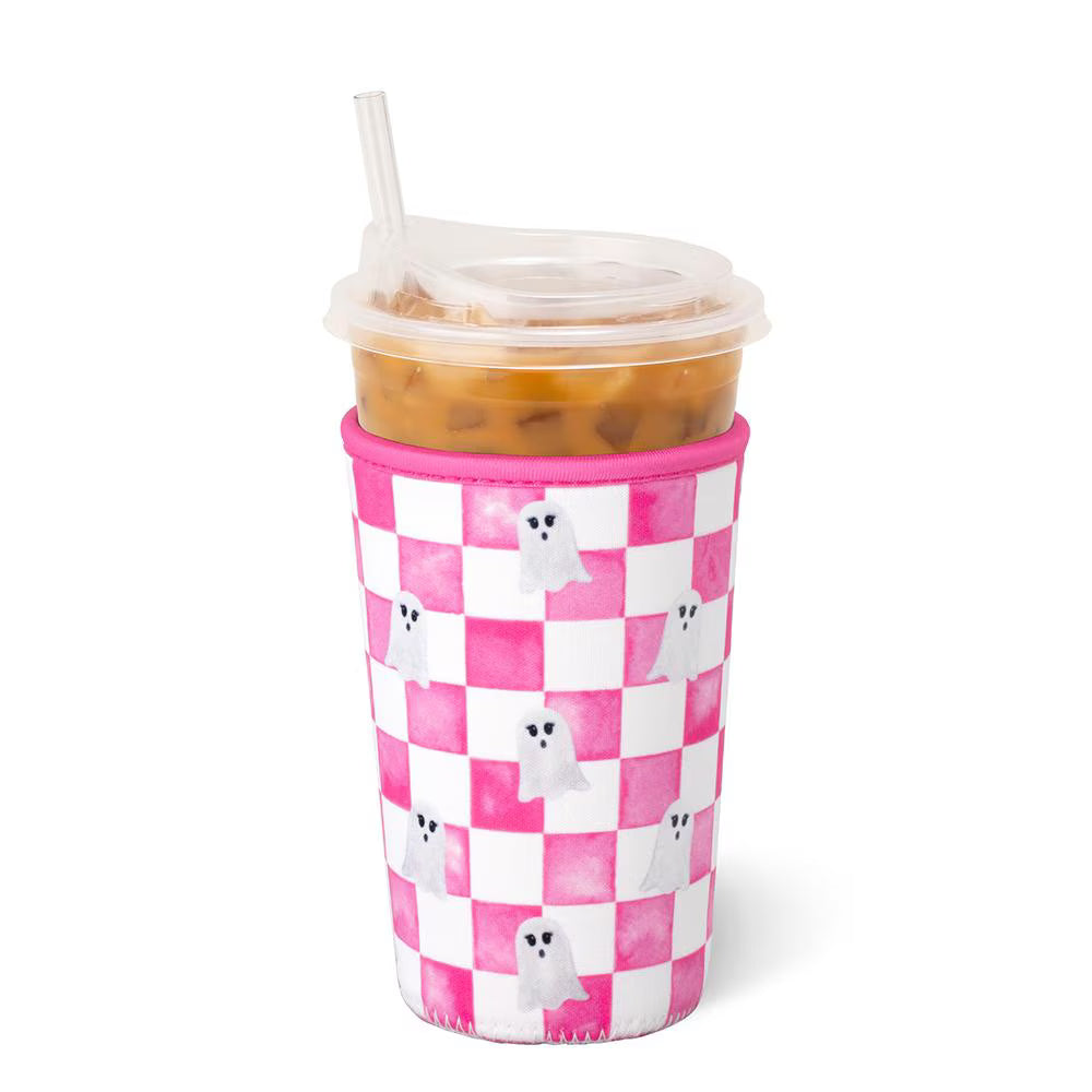 A pink and white checkered foam cup sleeve on a clear plastic cup with a straw, filled with iced coffee, on a white background.