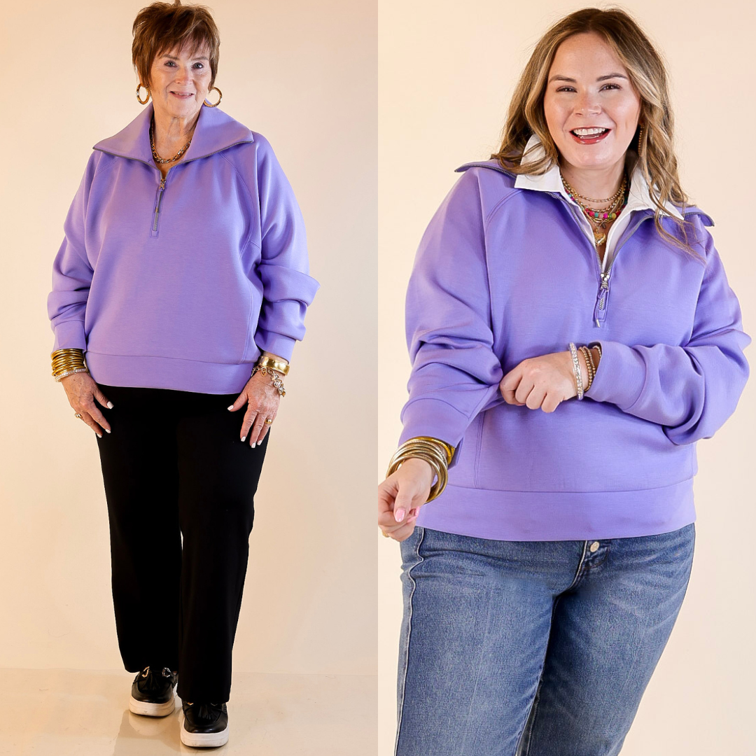 Models are wearing SPANX Air Essentials Half Zip in Amethyst Purple against a beige background.