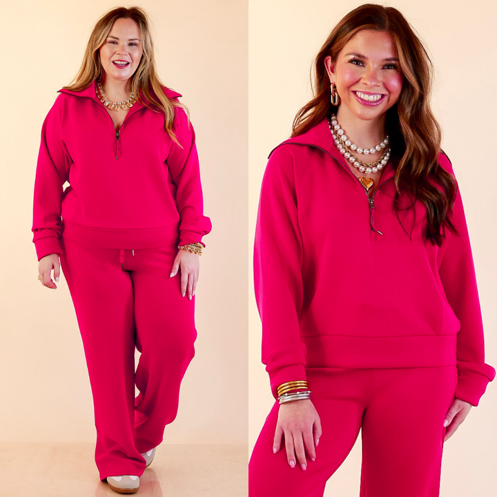 Models are wearing SPANX AirEssentials Half Zip in Fuchsia Pink against a beige backdrop. 