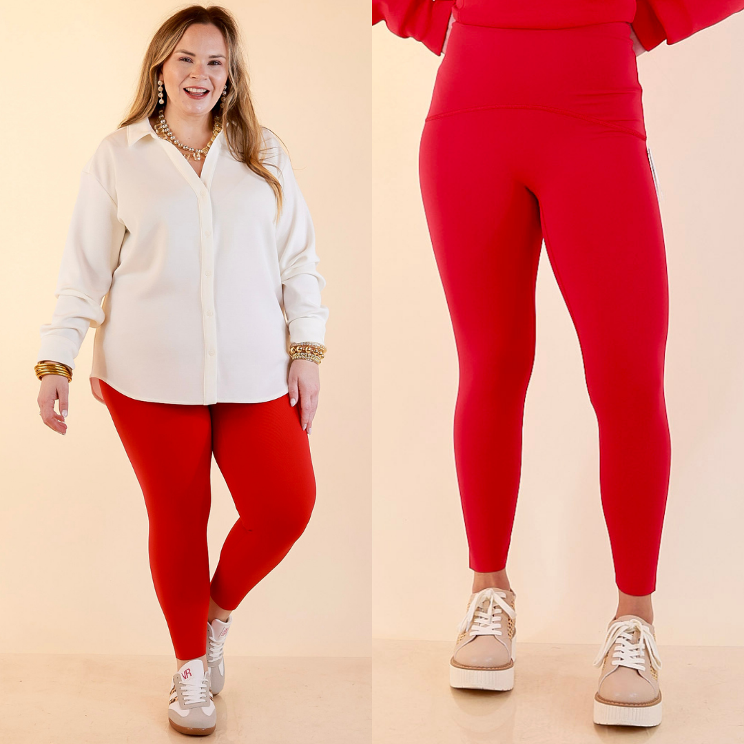 Models are wearing SPANX Booty Boost Performance and Shaping 78 Leggings in Red against a beige backdrop. 
