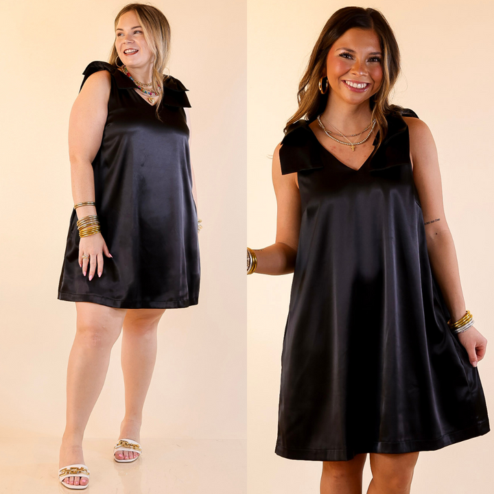 Models are wearing V-neck mini dress with bow strap detailing in black on a beige background