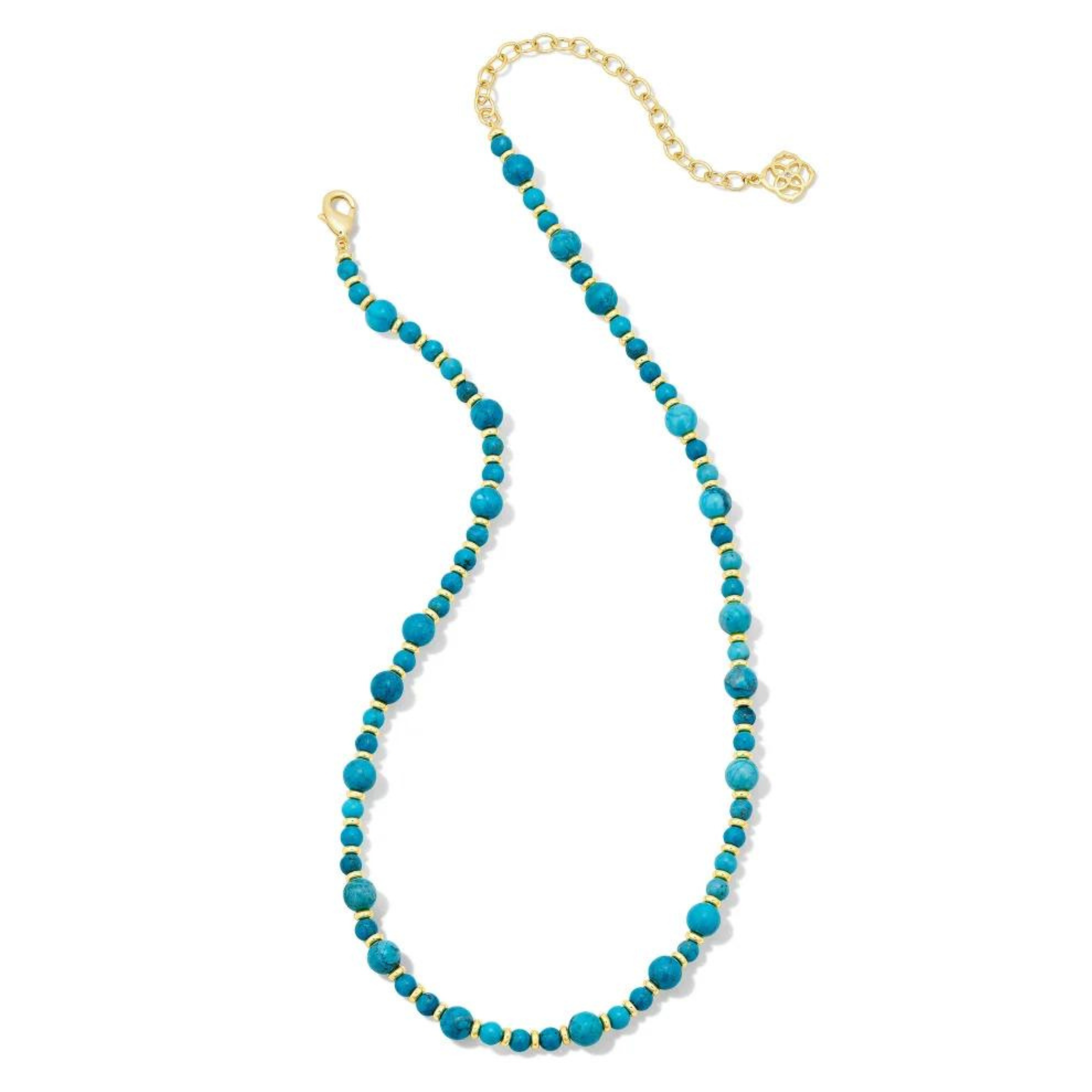 Gold spacers and carying size dark teal marble beaded necklace. This necklace is pictured on a white background. 