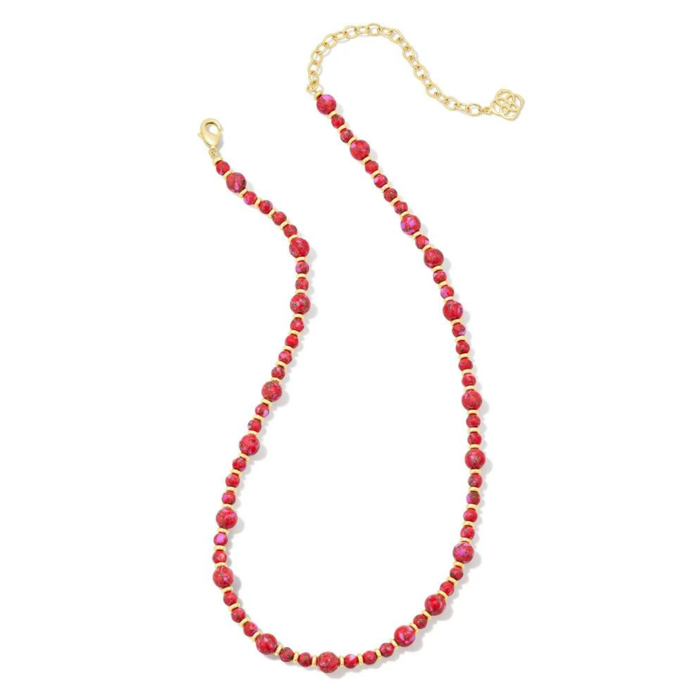Gold spacers and varying size red marble beaded necklace. This necklace is pictured on a white background. 