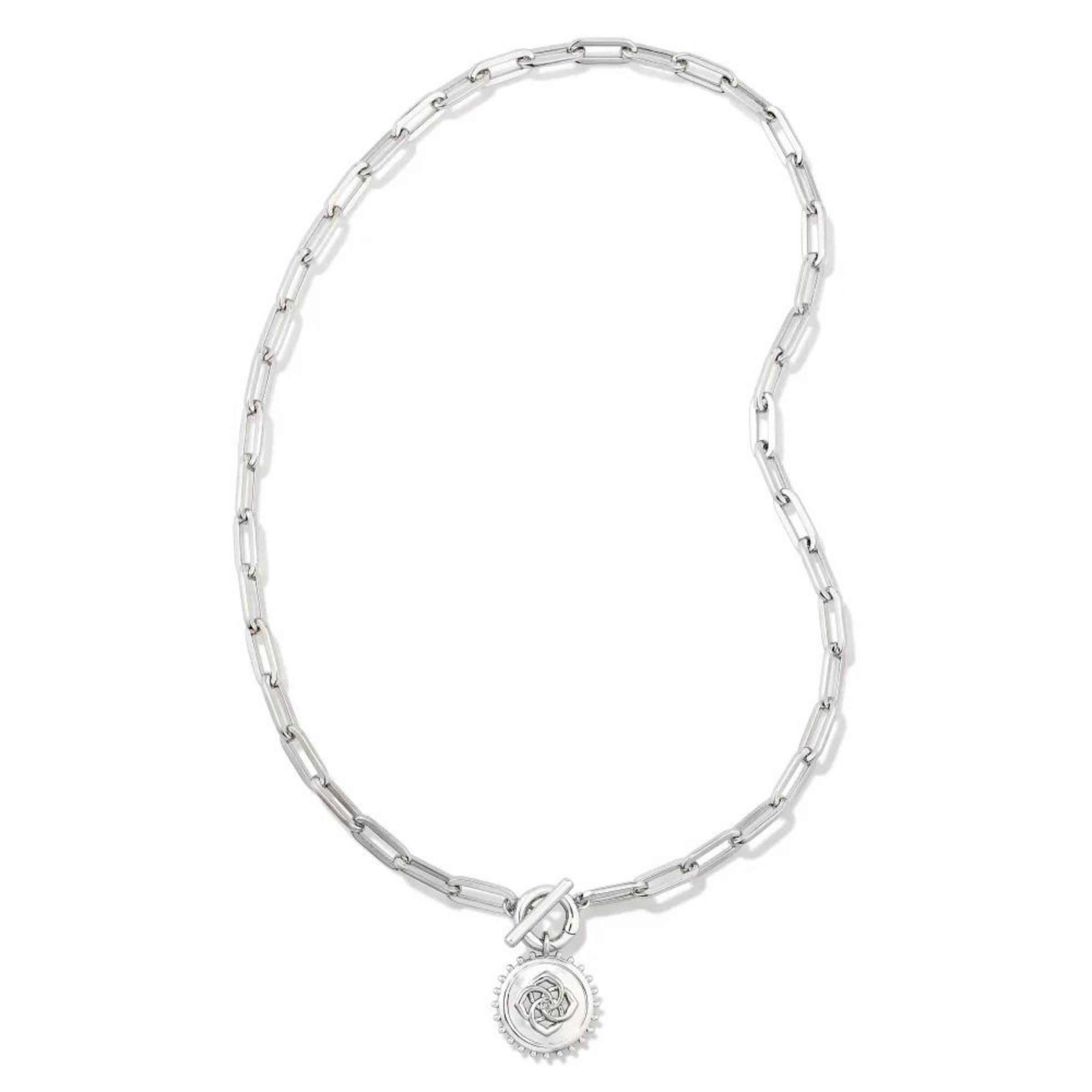 Silver, paperclip chain necklace with a toggle front clasp. This necklace also includes a silver medallion charm. This necklace is pictured on a white background. 