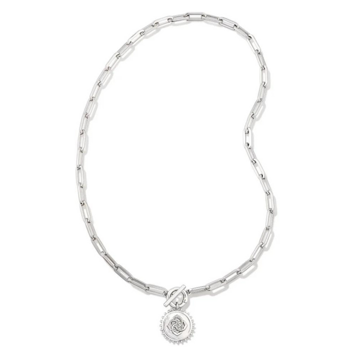 Silver, paperclip chain necklace with a toggle front clasp. This necklace also includes a silver medallion charm. This necklace is pictured on a white background. 