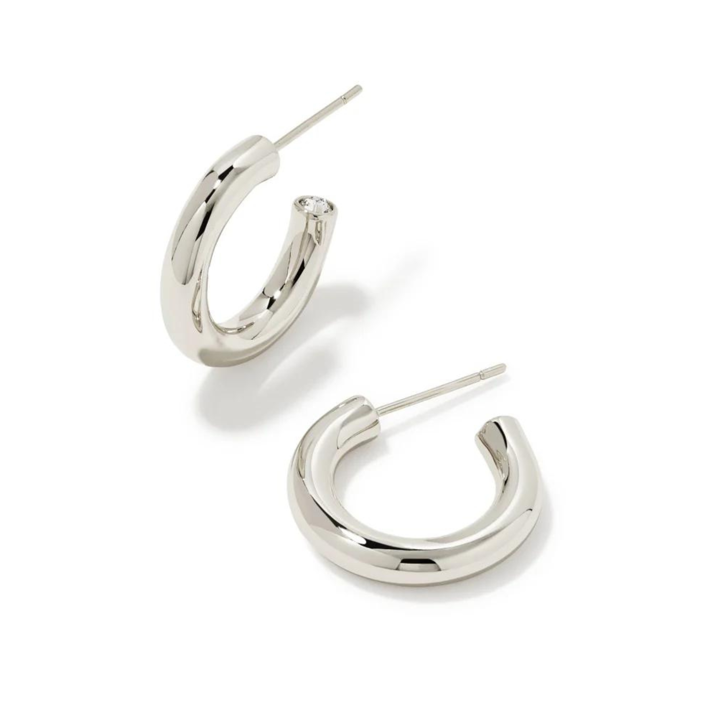 Pictured is a pair of silver hoop earrings on a white background.