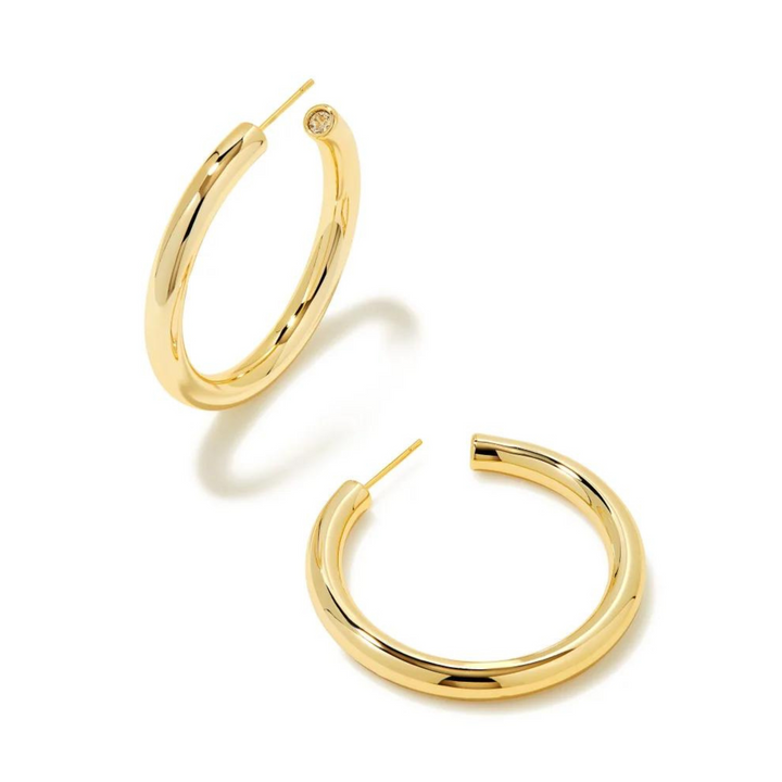 Pictured is a pair of gold hoop earrings on a white background.
