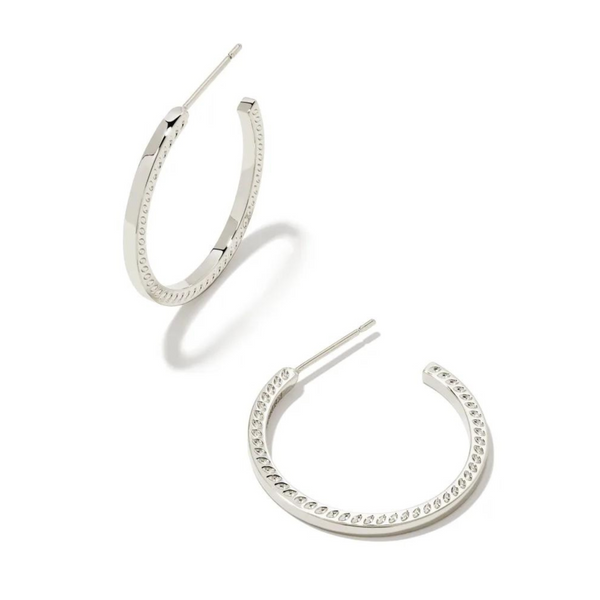 Pictured is a pair of silver hoop earrings on a white background.