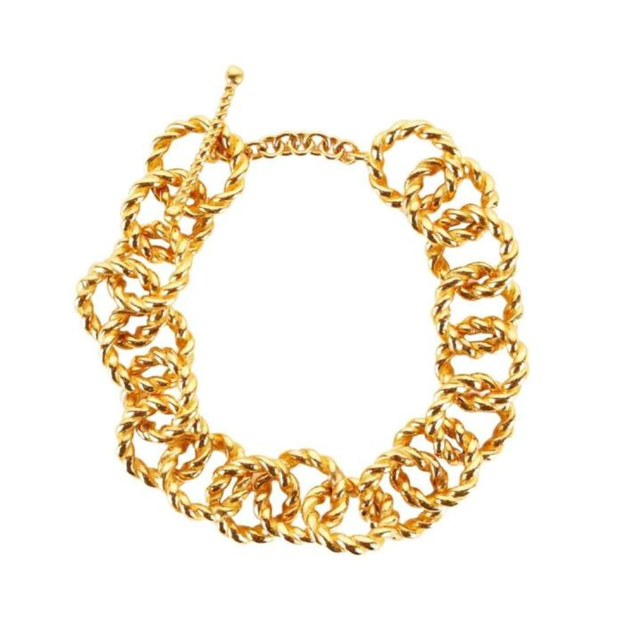 Textured, gold chain bracelet with a toggle clasp pictured on a white background. 