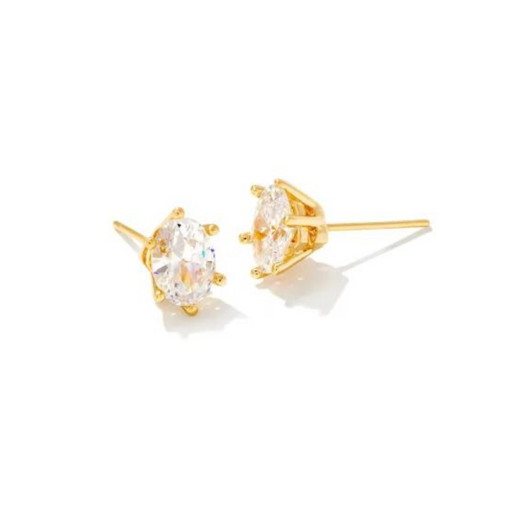 Pictured on a white background is a pair of gold stud earrings with a single oval, clear crystal. 