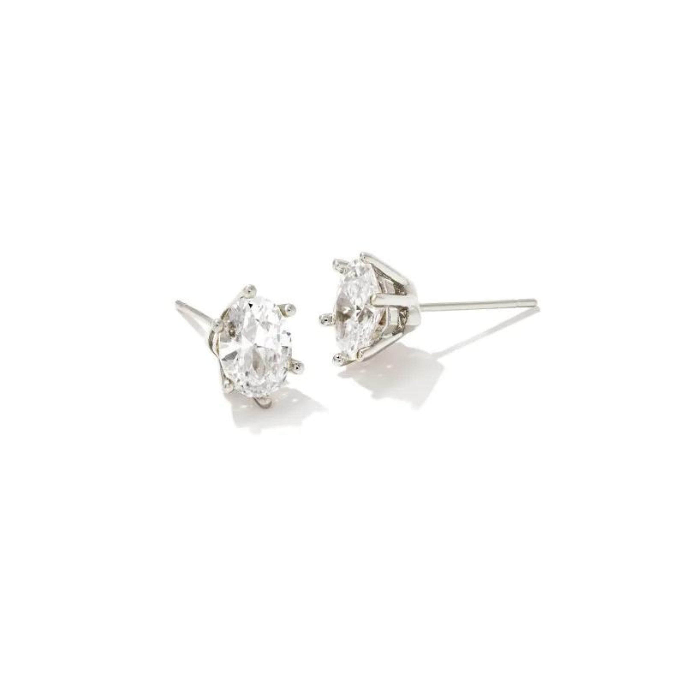 Pictured on a white background is a pair of silver stud earrings with a single oval, clear crystal. 