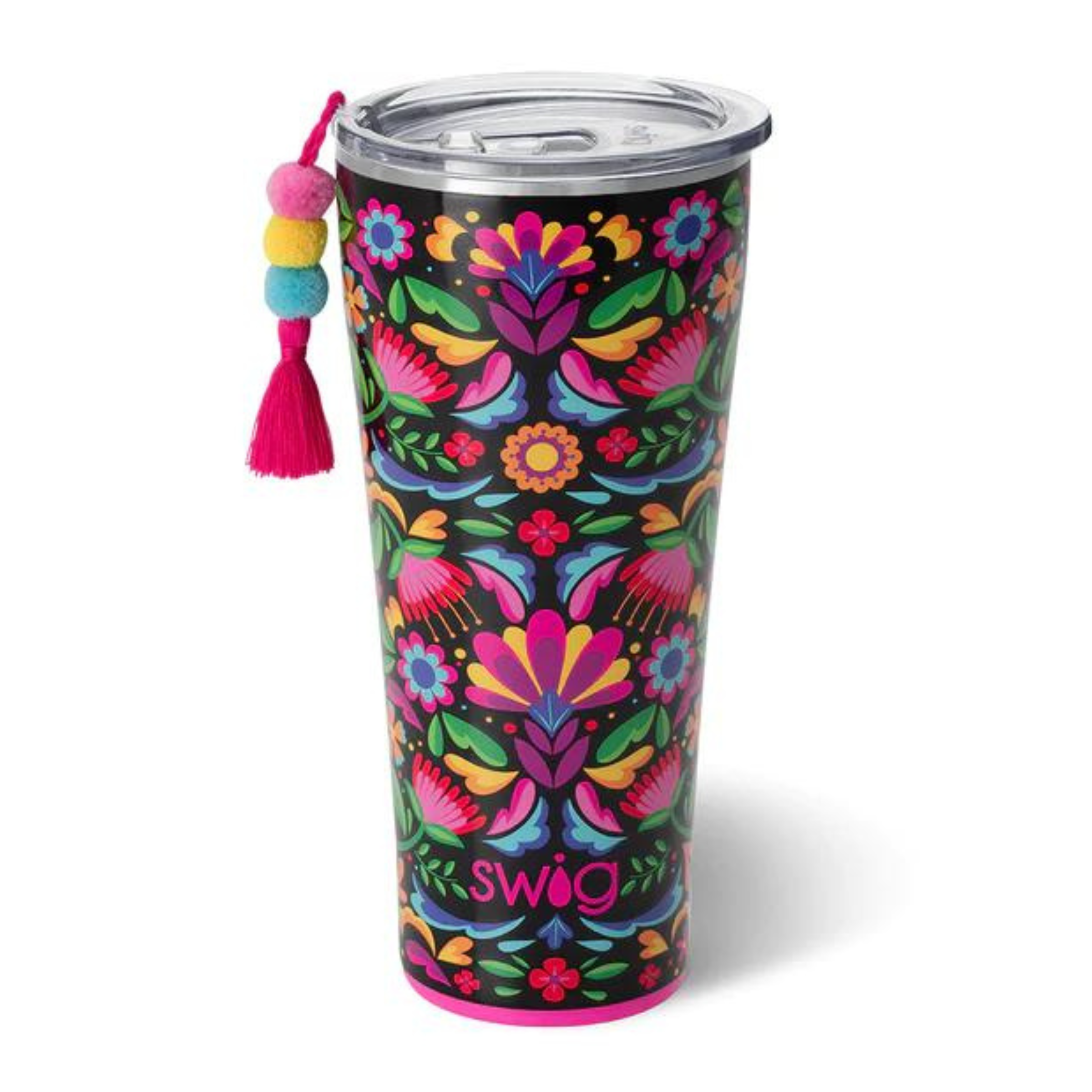 Pictured on a white background is a black tumbler with a clear lid and a pink base. This cup has a multicolored print and tassel on the left side of the cup. 