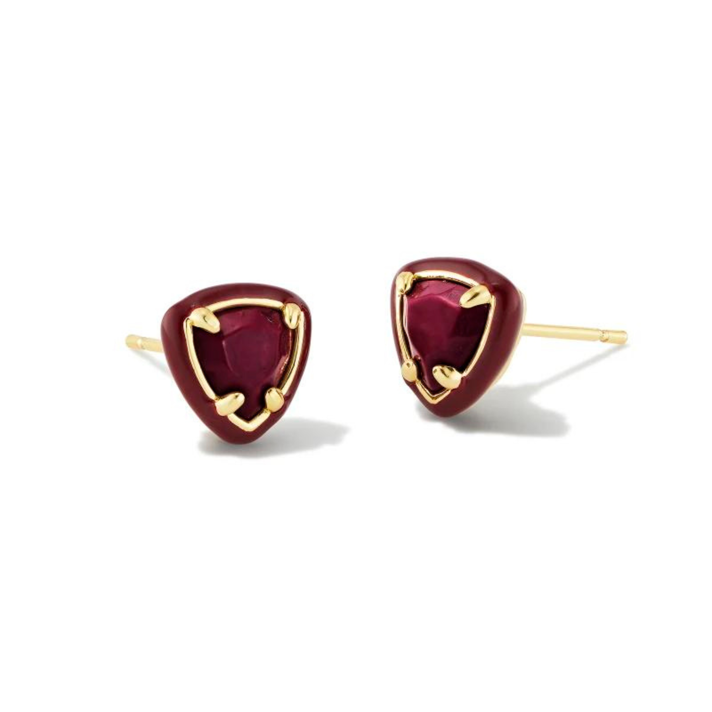 Maroon framed, triangle shaped stud earrings with a center maroon stone and a gold ear post. These earrings are pictured on a white background. 