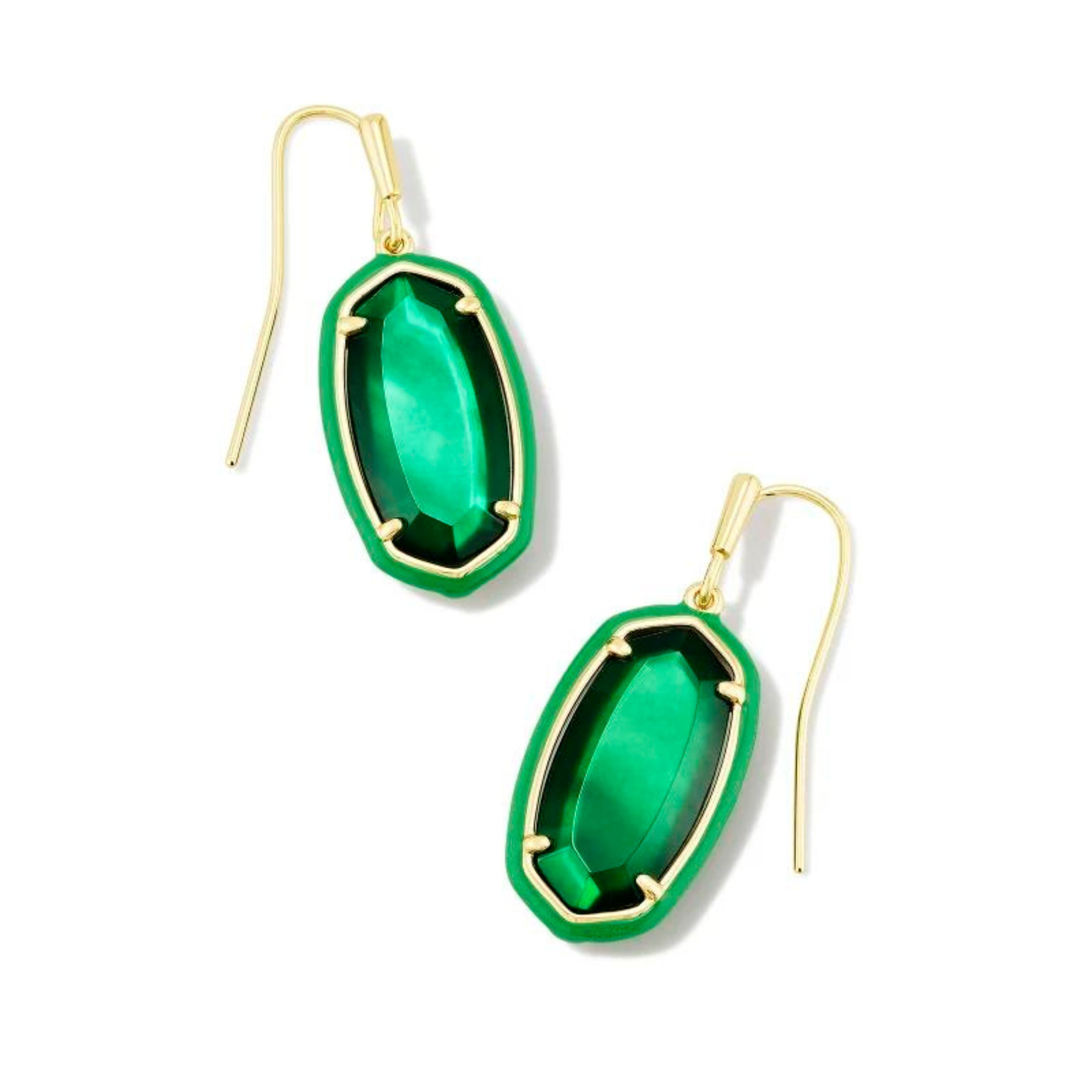 Emerald framed, oval shaped drop earrings with a center emerald stone and a gold fish hook earring. These earrings are pictured on a white background. 