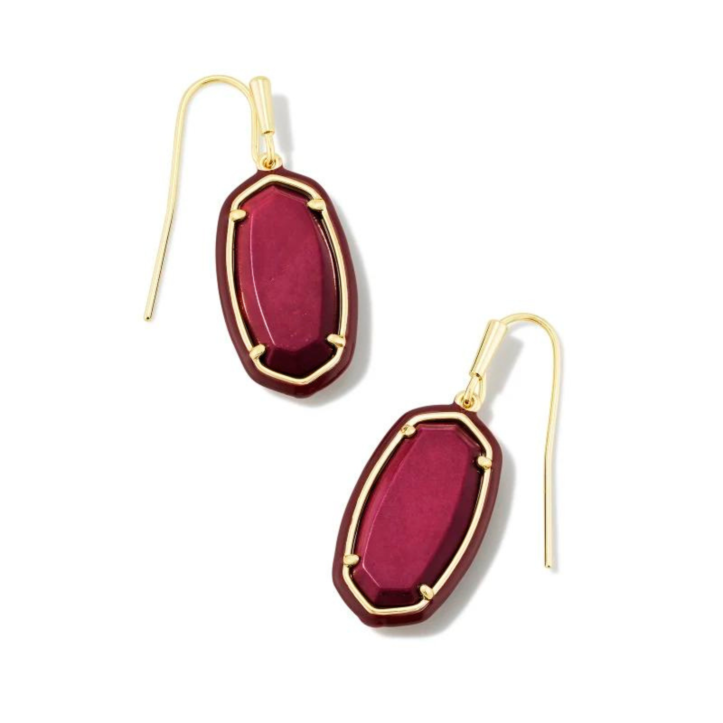 Maroon framed, oval shaped drop earrings with a center maroon stone and a gold fish hook earring. These earrings are pictured on a white background. 
